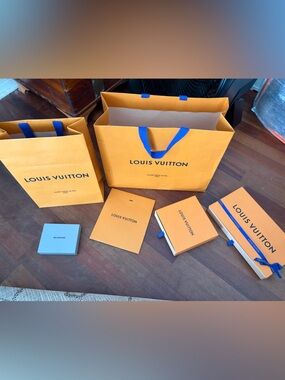 Louis Vuitton Orange Bag and Box Packaging with Blue Handles and Ribbons
